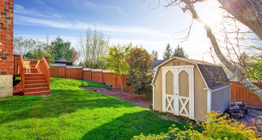 Fenced backyard with storage shed in Brooklyn